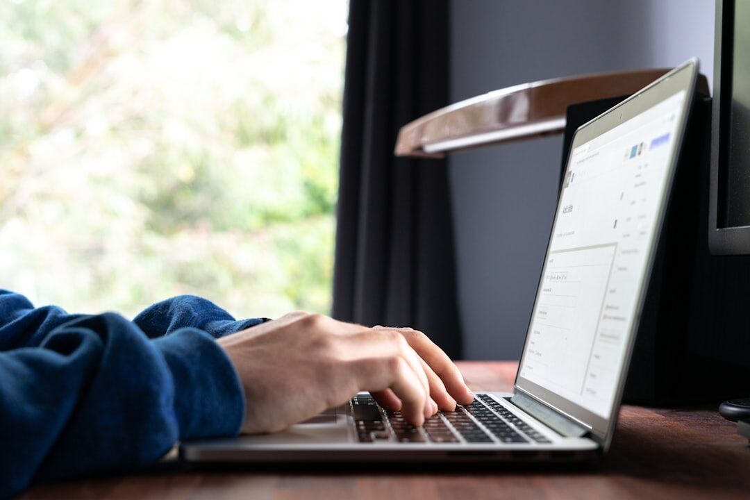 person coding on laptop