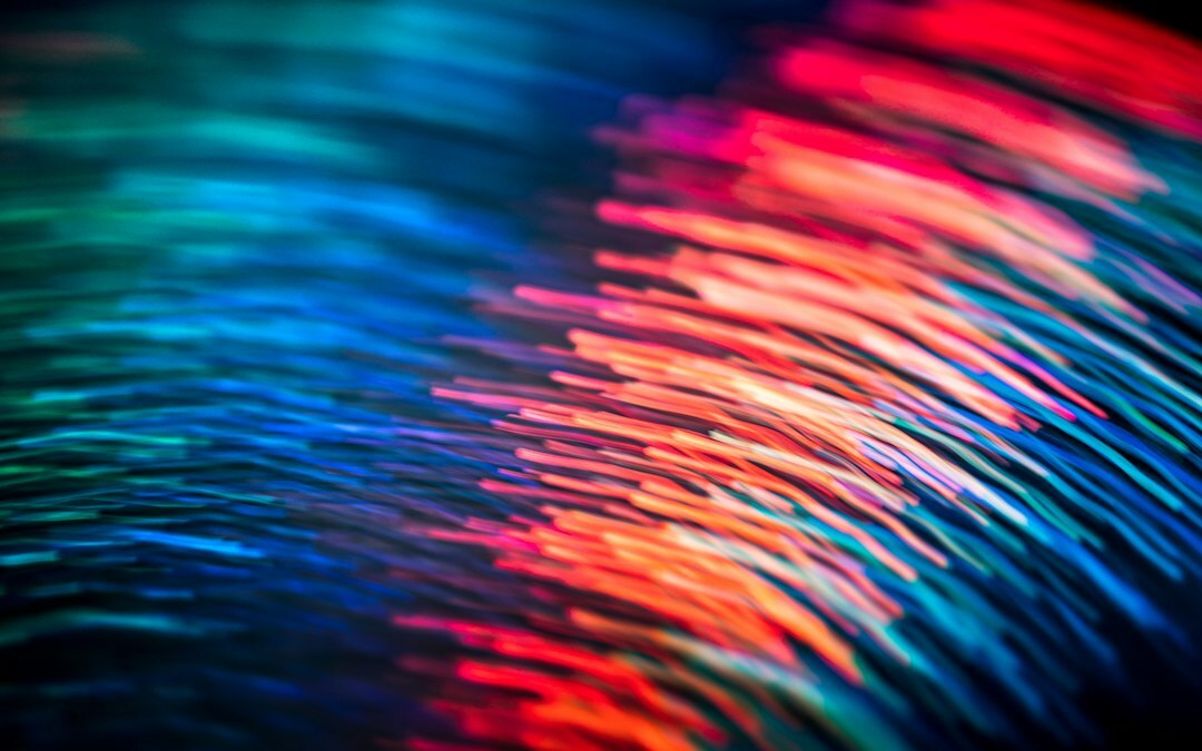 Laptop screen showing colorful lines of programming code